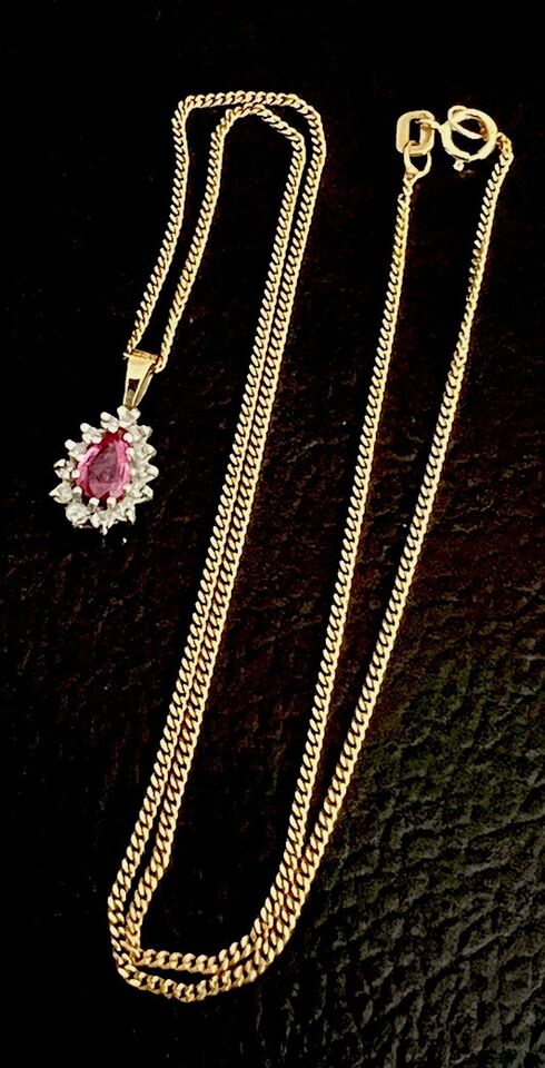gold necklace with a pink sapphire